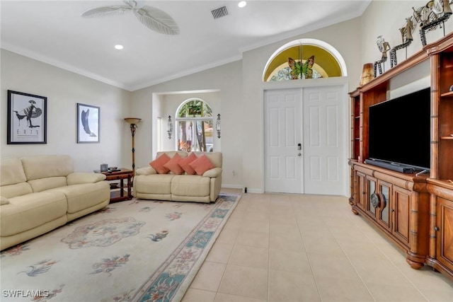 living room with light tile patterned flooring, visible vents, and crown molding