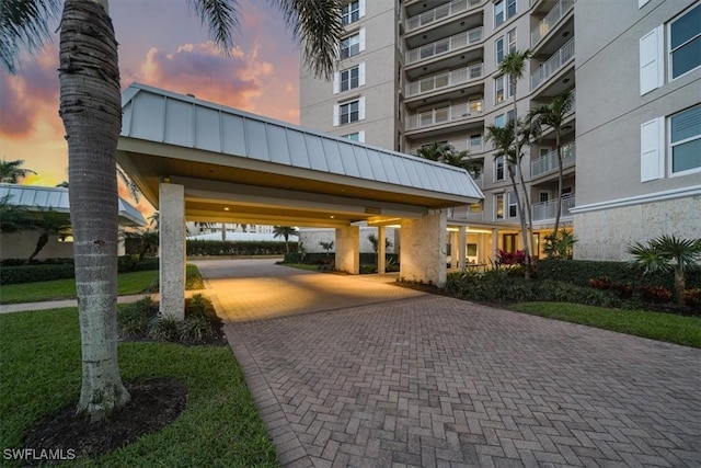 view of community with decorative driveway