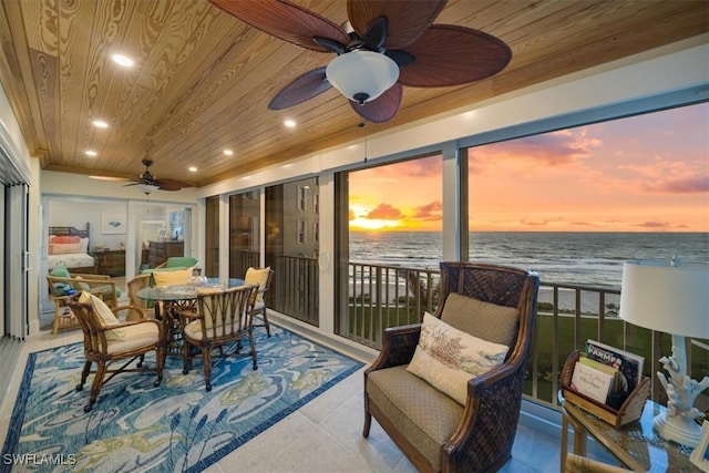 dining room with a water view, recessed lighting, wooden ceiling, tile patterned floors, and a ceiling fan