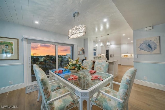 dining area with light wood-style flooring, recessed lighting, and baseboards