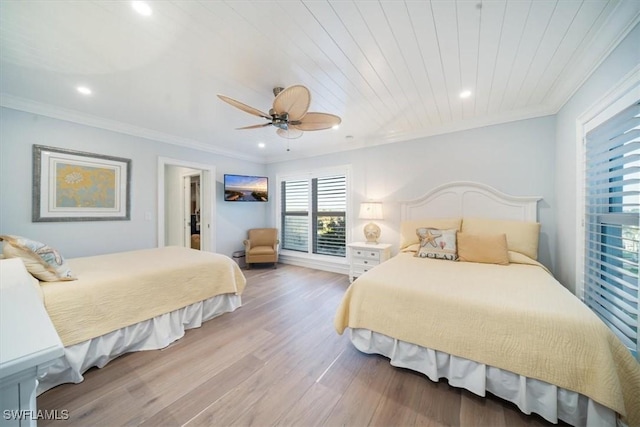 bedroom with ornamental molding, wood finished floors, recessed lighting, ceiling fan, and a spacious closet