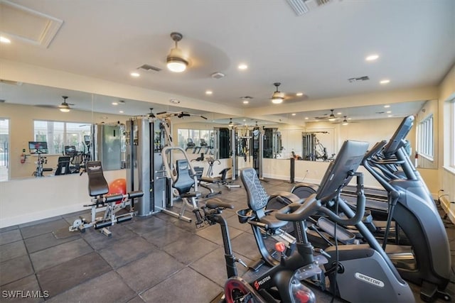 gym with a ceiling fan, visible vents, and baseboards