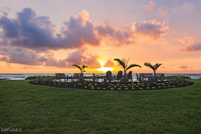 view of property's community with a yard and a water view