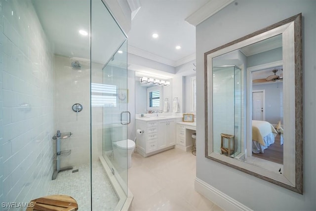 bathroom with vanity, toilet, a stall shower, and crown molding