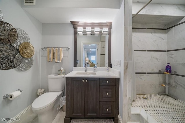 full bath with visible vents, toilet, tiled shower, and vanity