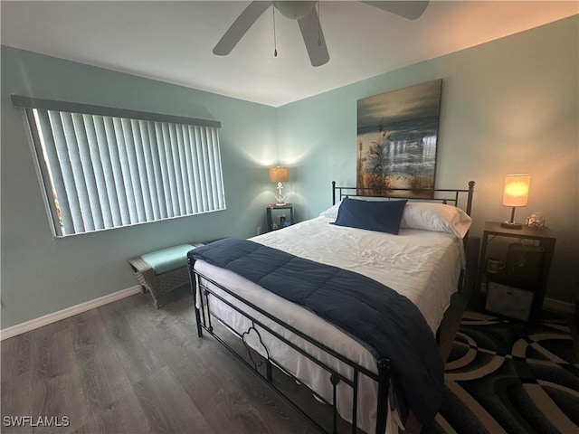 bedroom featuring a ceiling fan, wood finished floors, and baseboards