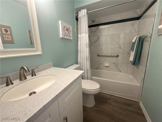 bathroom with baseboards, toilet, wood finished floors, vanity, and shower / bathtub combination with curtain