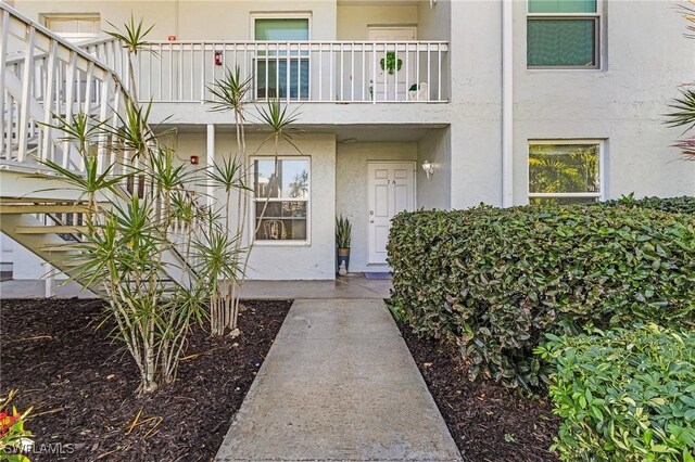 entrance to property featuring stucco siding