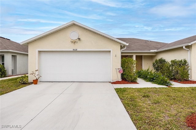 ranch-style home featuring a garage, driveway, and stucco siding