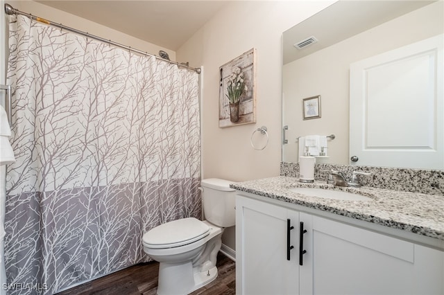 full bathroom featuring vanity, toilet, wood finished floors, and visible vents