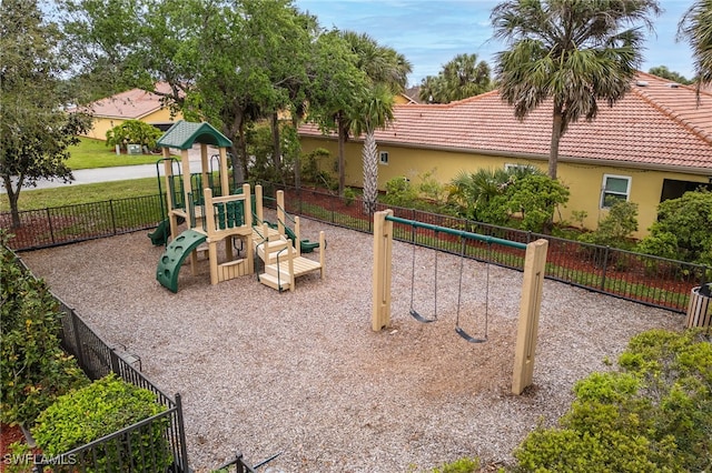 community playground with fence and a lawn