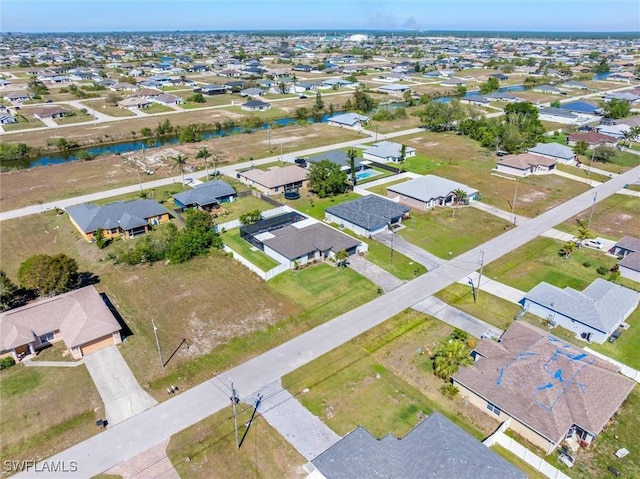 drone / aerial view featuring a residential view and a water view