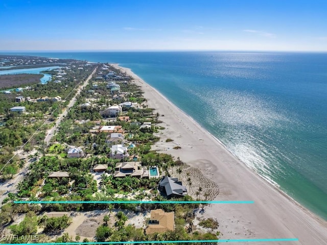 birds eye view of property featuring a view of the beach and a water view