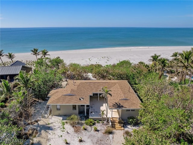 drone / aerial view featuring a beach view and a water view