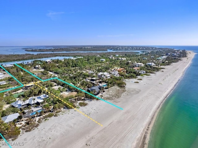 aerial view with a water view and a beach view