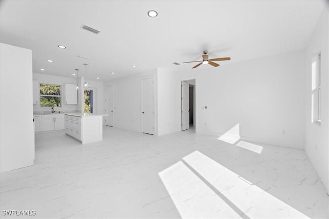 unfurnished living room with recessed lighting, visible vents, marble finish floor, and ceiling fan