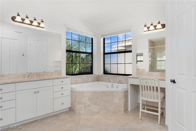 bathroom with tile patterned flooring, a stall shower, vanity, and a bath