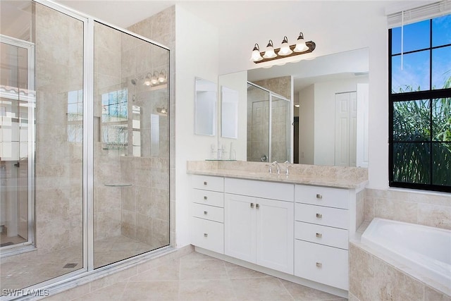 full bathroom featuring vanity, a garden tub, a stall shower, and tile patterned flooring