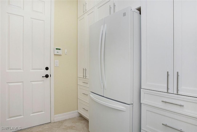 interior space featuring tile patterned floors and baseboards