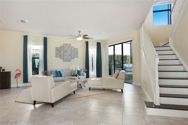 living area with a wealth of natural light, visible vents, and light tile patterned floors