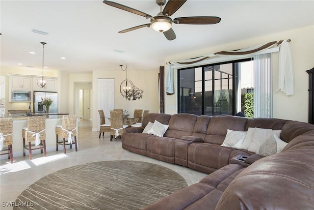 living area with recessed lighting, visible vents, and ceiling fan with notable chandelier