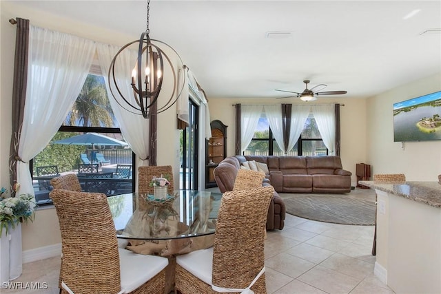 dining space with light tile patterned floors, baseboards, and ceiling fan with notable chandelier