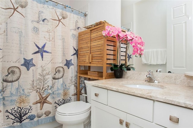 bathroom featuring a shower with shower curtain, toilet, and vanity