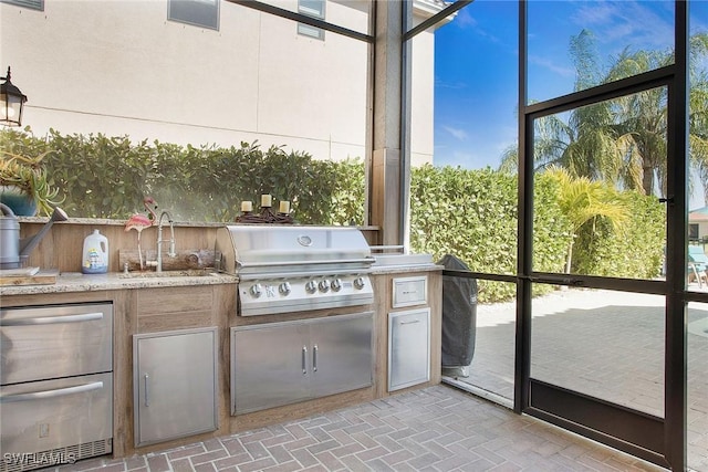 view of patio with grilling area, exterior kitchen, and a sink