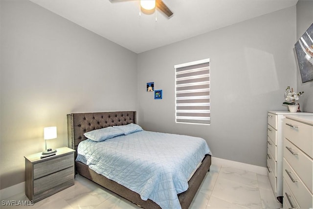 bedroom featuring marble finish floor, baseboards, and a ceiling fan