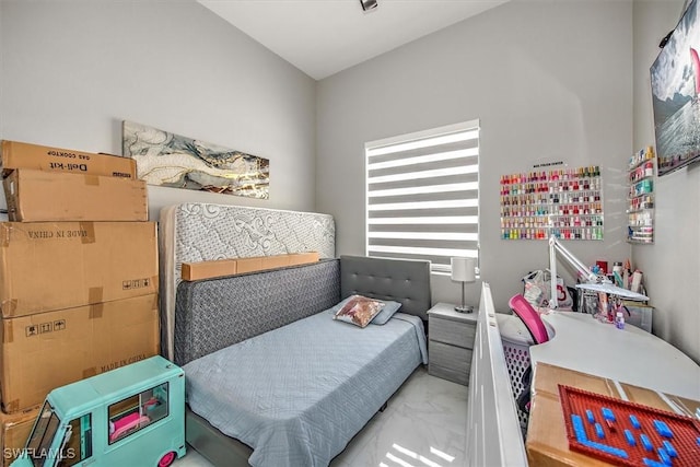 bedroom featuring marble finish floor