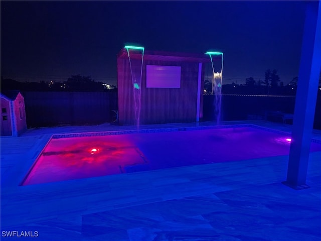 pool at night with fence