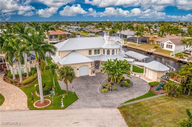 birds eye view of property with a residential view and a water view