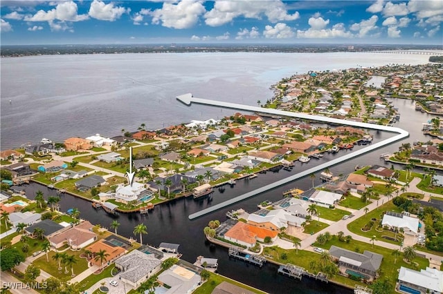 drone / aerial view featuring a residential view and a water view