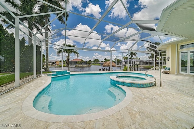 view of swimming pool with glass enclosure, a patio, and a pool with connected hot tub