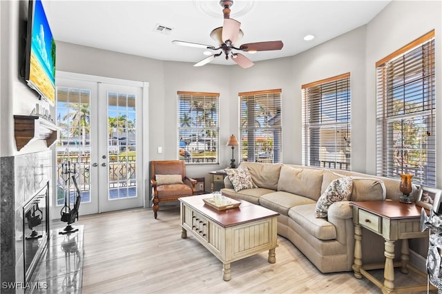 living area with a wealth of natural light, visible vents, and french doors