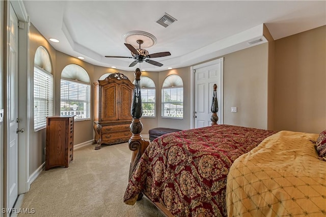 bedroom featuring a ceiling fan, baseboards, visible vents, and light carpet