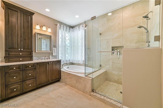 full bathroom with tile patterned flooring, a stall shower, vanity, and a garden tub