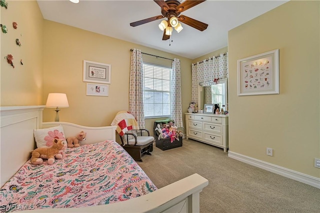 carpeted bedroom with baseboards and a ceiling fan