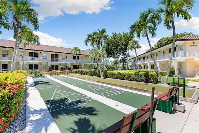 view of property's community featuring shuffleboard and a residential view