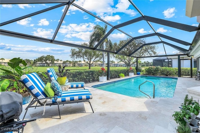 pool featuring glass enclosure, a grill, and a patio area