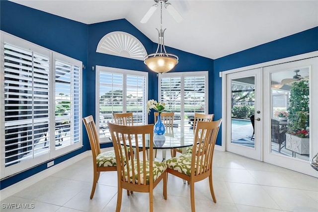 dining area with light tile patterned floors, french doors, plenty of natural light, and lofted ceiling