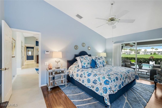 bedroom with visible vents, high vaulted ceiling, a ceiling fan, access to outside, and wood finished floors