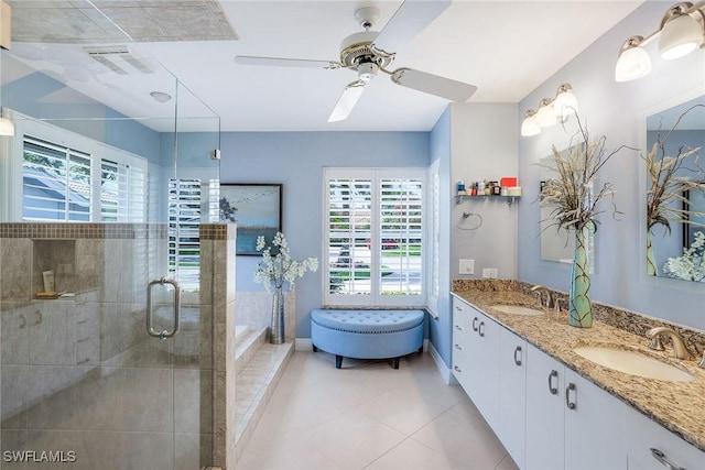 full bath featuring double vanity, a stall shower, visible vents, and a sink