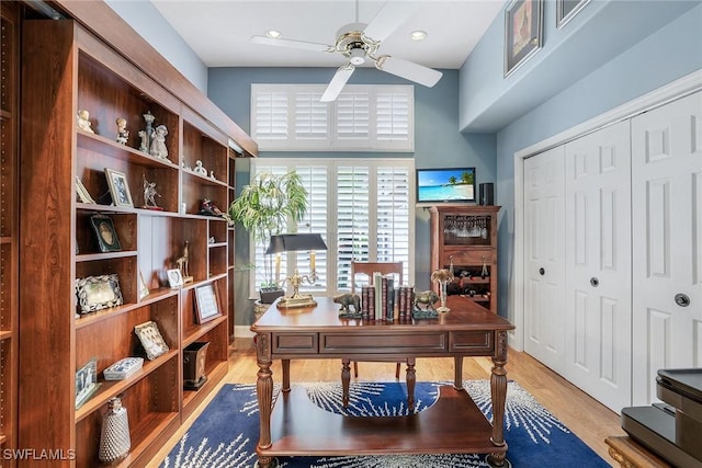 home office featuring light wood finished floors and ceiling fan