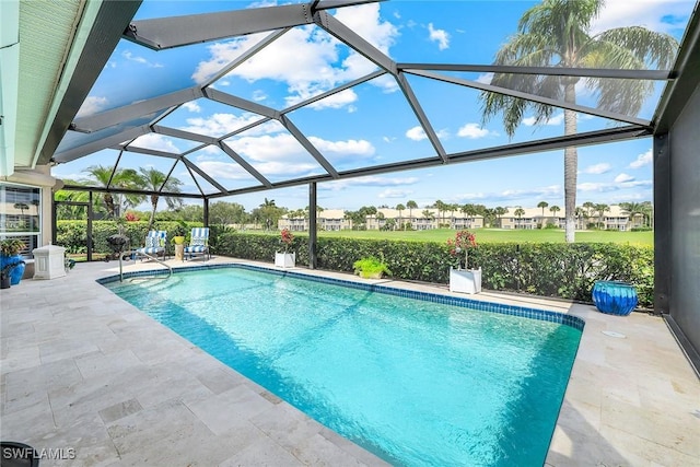 pool with glass enclosure and a patio area