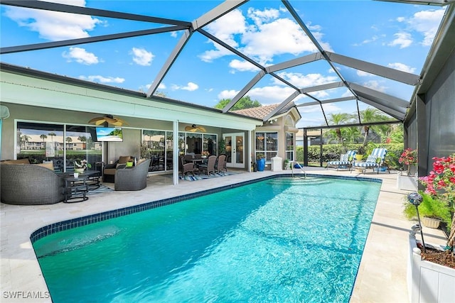 pool with a lanai, an outdoor hangout area, french doors, a patio, and a ceiling fan