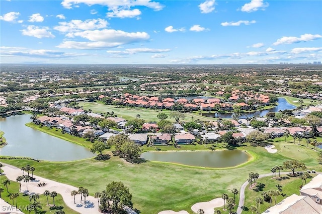 birds eye view of property with golf course view, a water view, and a residential view