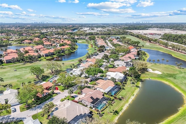 bird's eye view featuring golf course view, a water view, and a residential view