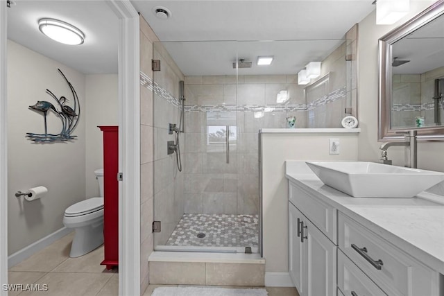 bathroom with baseboards, toilet, a stall shower, tile patterned floors, and vanity