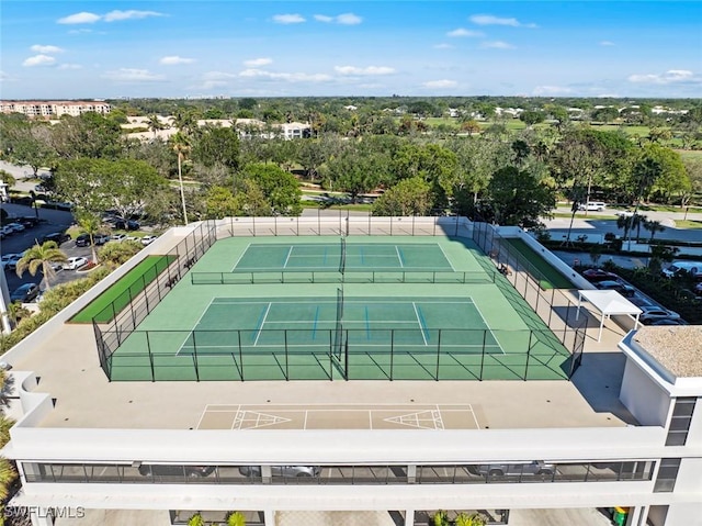 view of tennis court featuring fence